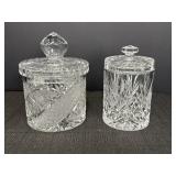 2 clear glass lidded jars.  7in & 6in heights with