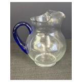Large clear glass pitcher w/blue glass handle,