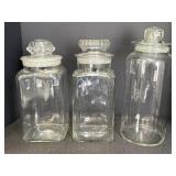 3 lg clear glass apothecary jars w/lids.  11.5 &