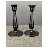 Pair of black pressed glass candlestick holders,