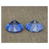 2 sapphire blue faceted glass paperweights in the