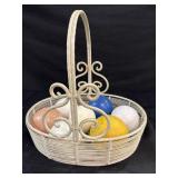 Metal oval basket with croquet balls