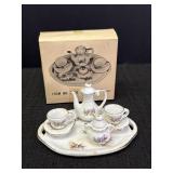 Miniature porcelain tea set.  Missing creamer