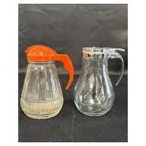 2 glass syrup dispensers, 5.5in high.  Plastic top