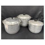 3 Wear-Ever aluminum pots w/lids.  All 3 lids have