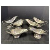 6 silver colored variety of gravy boats, possibly