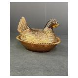 Amber glass hen on a nest, 7in length,