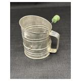Vtg. metal flour sifter w/green wooden knob,