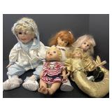 Variety of porcelain and rubber dolls