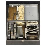 Variety of alphabet & number stamps in toolbox
