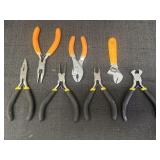 Variety of mini pliers and a wrench