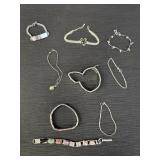 Variety of 9 silver tone bracelets.  Most are