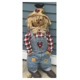 Fabric scarecrow decoration wearing denim overalls
