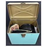Variety of vinyl records in metal container