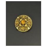 Gold tone dimensional brooch, filigree design w/