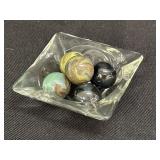 5 glass marble shooters in clear glass ashtray