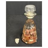 Arrowhead &  fire opal fragments in liquid in