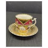 Ornate cup & saucer set, gold color & floral