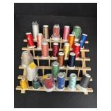 Wooden thread rack filled w/ assorted  spools of