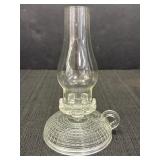 Candlestick holder fashioned as a clear glass