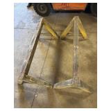 Heavy-duty, yellow-painted steel sawhorses,