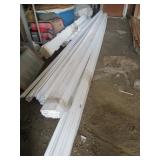 PILE OF PRIMED PINE MOLDING / TRIM