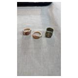 2 conch shell carved rings, 1 one dollar bill