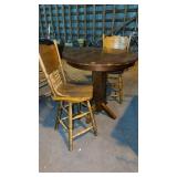 High top bar table with two oak press back,