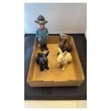 3 cast iron bunnies and man