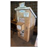 Out house on wheels and signs