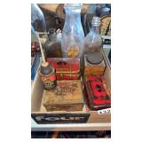 Box of milk and other bottles and tin advertising