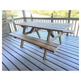 Wooden picnic table; has hole in middle for