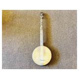 A vintage or antique banjo. It is missing a