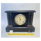 An antique mantel clock with key. Made by the