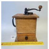 An antique wooden coffee grinder