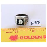 A ring with a initial D on it. The band is marked