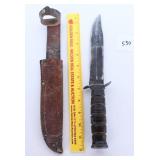 A large knife with sheath it is marked US
