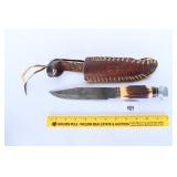 A large knife with sheath.