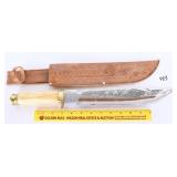 A large knife with sheath. Says Cancun Mexico