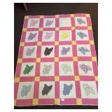 A vintage hand-stitched butterfly quilt. It