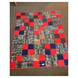 A vintage hand-stitched quilt. It measures