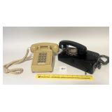 A pair of vintage phones including a black wall