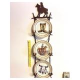 A metal cowboy or western themed plate hanger. It