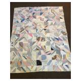 A vintage hand-stitched quilt. It does show heavy