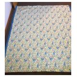 A vintage satin-trimmed blanket. It measures