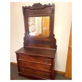 An antique dresser with mirror. Measures