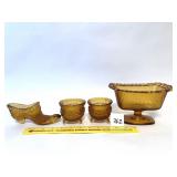 A Vintage amber daisy and button glass shoe. (2)