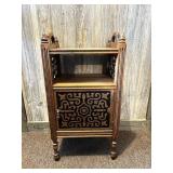 A vintage wooden smoke stand. The inside is