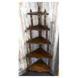 A vintage wooden corner shelf. It measures
