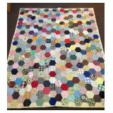A hand-stitched quilt. It does have some stains